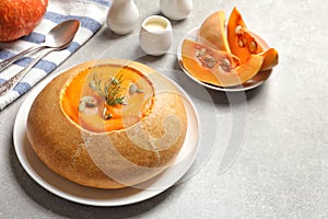 Tasty pumpkin soup served in bread