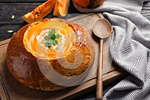 Tasty pumpkin soup served in bread