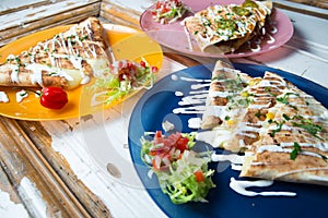 Tasty quesadillas on colorful plates ,Mexican street food