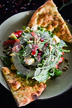 Tasty quinoa salad with fresh vegetables & focaccia bread