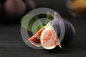 Tasty raw figs on black slate table