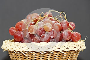 Tasty Red Grape In Wooden Basket