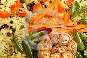 Tasty rice pilaf with vegetables as background, closeup