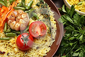 Tasty rice pilaf with vegetables on table, closeup