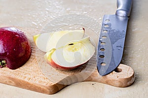 Tasty and ripe apples. Fruit sprinkled with water on a wooden kitchen table.