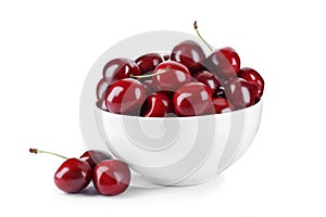 Tasty ripe red cherries and bowl isolated