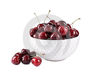 Tasty ripe red cherries and bowl isolated