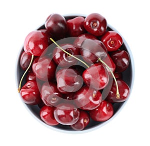 Tasty ripe red cherries in bowl isolated on white