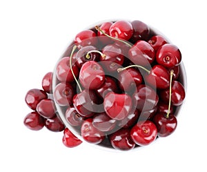 Tasty ripe red cherries and bowl isolated on white