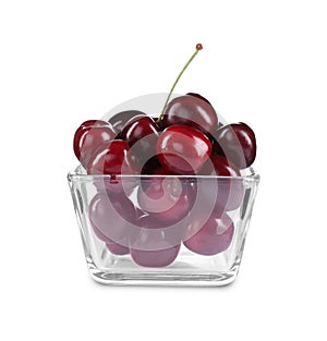 Tasty ripe red cherries in glass bowl isolated