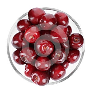 Tasty ripe red cherries in glass bowl isolated, top view