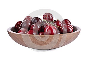 Tasty ripe red cherries in wooden bowl isolated