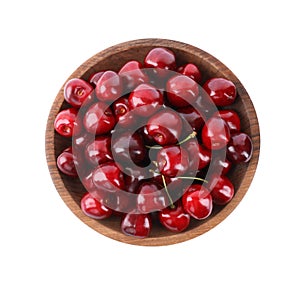 Tasty ripe red cherries in wooden bowl isolated, top view