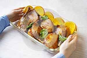 Tasty roast duck made in orange sauce. Oven-baked duck garnished with oranges and spinach.
