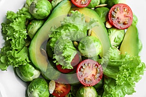 Tasty salad with Brussels sprouts on plate, top view