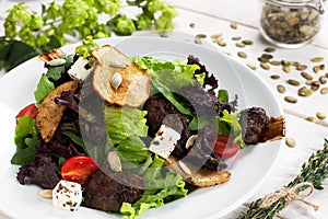 Tasty salad with fried mushrooms and vegetables