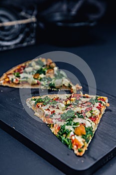 Tasty salami pizza and cooking ingredients tomatoes basil on a background. Top view