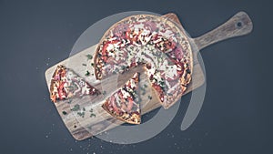 Tasty salami pizza and cooking ingredients tomatoes basil on a background. Top view