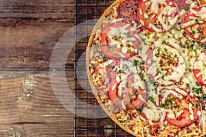 Tasty salami pizza and cooking ingredients tomatoes basil on a background. Top view