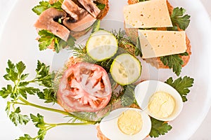 Tasty sandwiches on a plate and forks on a table