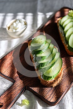 Tasty sandwiches with soft cheese and fresh cucumbers