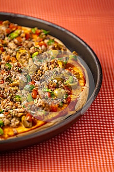 A tasty sardine pizza with olives, tomatoes and onions