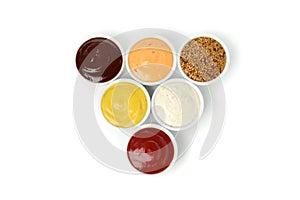 Tasty sauces in bowls isolated on background photo