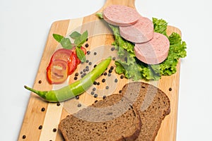 Tasty sausage and bread with lettuce and tomato for lunch and dinner