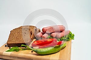 Tasty sausage and bread with lettuce and tomato for lunch and dinner