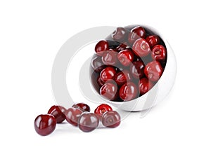 Tasty scattered red cherries and bowl isolated