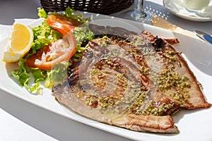 Tasty seafood, grilled tuna fish steaks served on outdoor terrace on Puerto Naos, La Palma, Canary islands, Spain