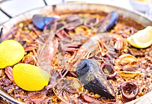 Tasty Seafood Paella in black pan -traditional spanish rice dish