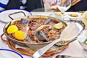 Tasty Seafood Paella in black pan -traditional spanish rice dish