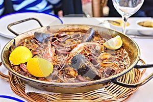 Tasty Seafood Paella in black pan -traditional spanish rice dish