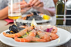 Tasty seafood on plate on table close-up, Siurana, Catalunya, Spain.