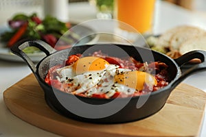 Tasty Shakshouka served on white table, closeup. Traditional Arabic dish