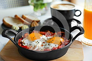 Tasty Shakshouka served on white table, closeup. Traditional Arabic dish