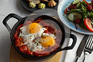 Tasty Shakshouka served on white table, closeup. Traditional Arabic dish