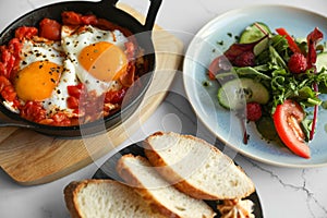 Tasty Shakshouka served on white table. Traditional Arabic dish