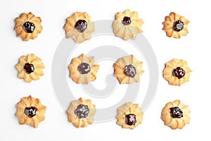 Tasty shortbread cookies with jam on white background