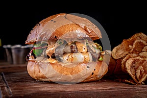 Tasty shrimp and beef burger with french fries