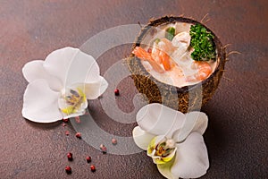 Tasty Shrimp soup with coconut milk, kaffir lime leaves, galangal, chilli and lemon grass in a coconut