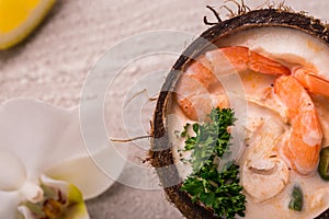 Tasty Shrimp soup with coconut milk, kaffir lime leaves, galangal, chilli and lemon grass in a coconut