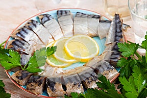 Tasty sliced lightly salted mackerel with greens and lemon