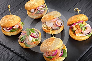 Tasty small burgers with seafood salad