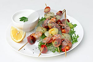 Tasty snack in fusion style: shrimp, potatoes and tomatoes in bowl