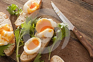 Tasty soft boiled eggs and salad greens