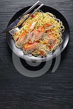 Tasty spaghetti with Crab on black plate