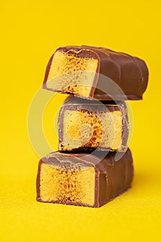 Tasty Stacked Chocolate Honeycomb Treat on yellow background