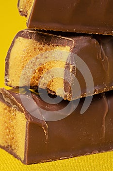 Tasty Stacked Chocolate Honeycomb Treat on yellow background